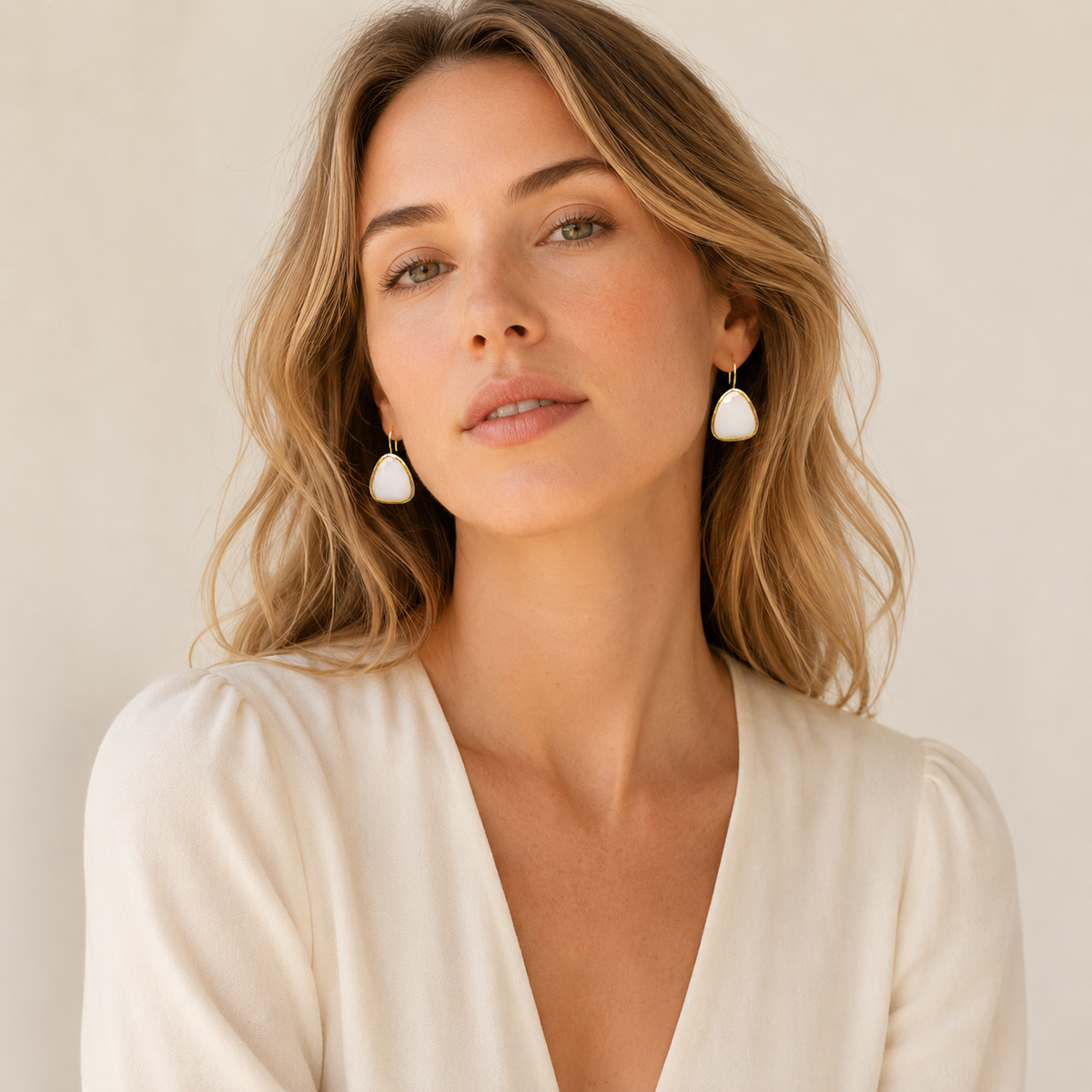 Pair of white chalcedony drop earrings with polished gold-plated hooks.