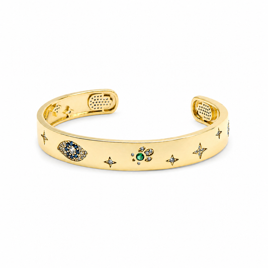 Gold-tone cuff bracelet with evil eye and Hamsa-inspired details.