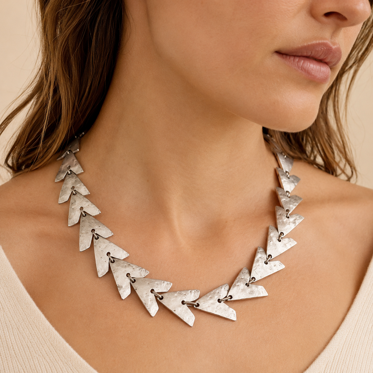 Triangle link statement necklace shown in a clean front view.