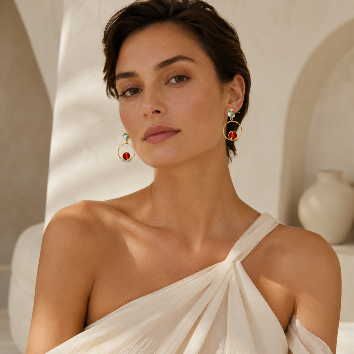 Pair of gold-plated drop earrings with faceted orange and teal details.