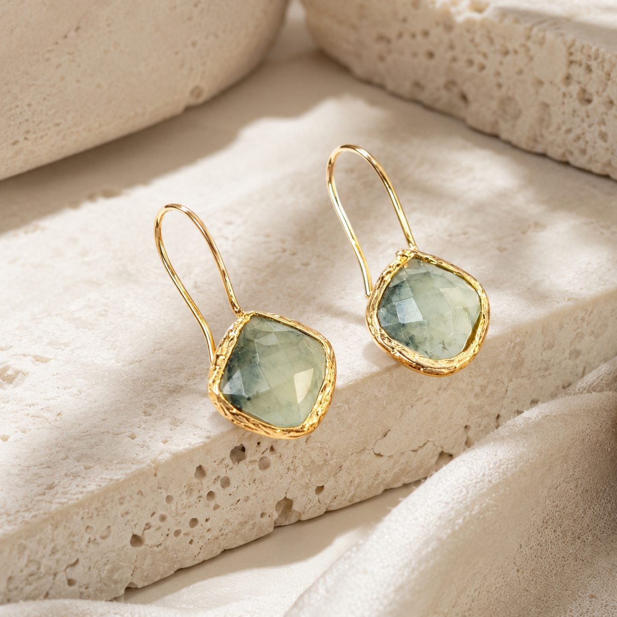 Angle view of green aventurine drop earrings with a gold-plated frame.