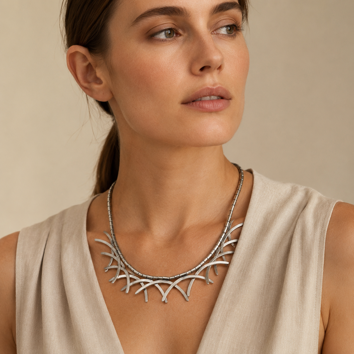 Silver-tone abstract branch collar necklace with curved layered details.