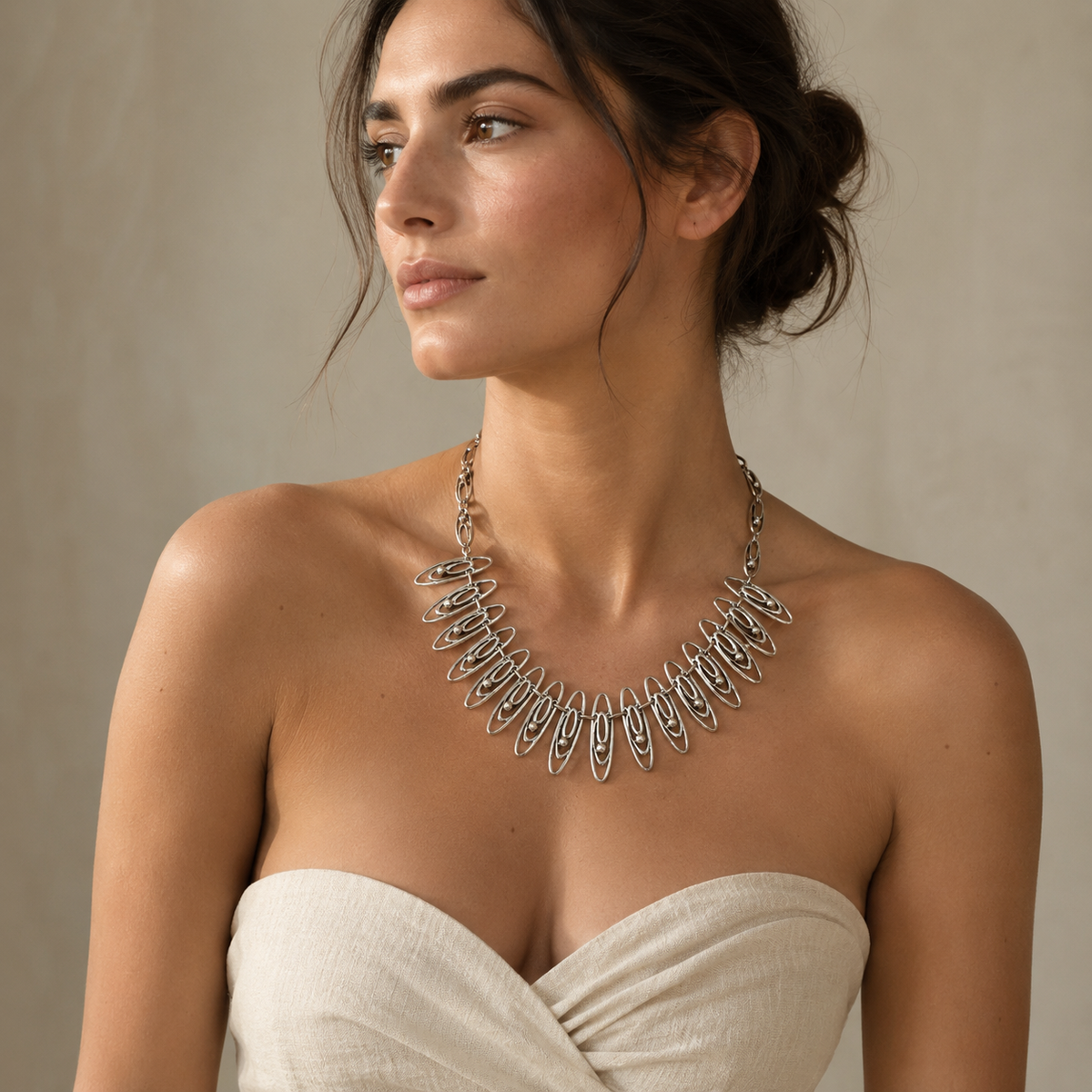 Statement necklace with layered oval links and silver-tone shine.