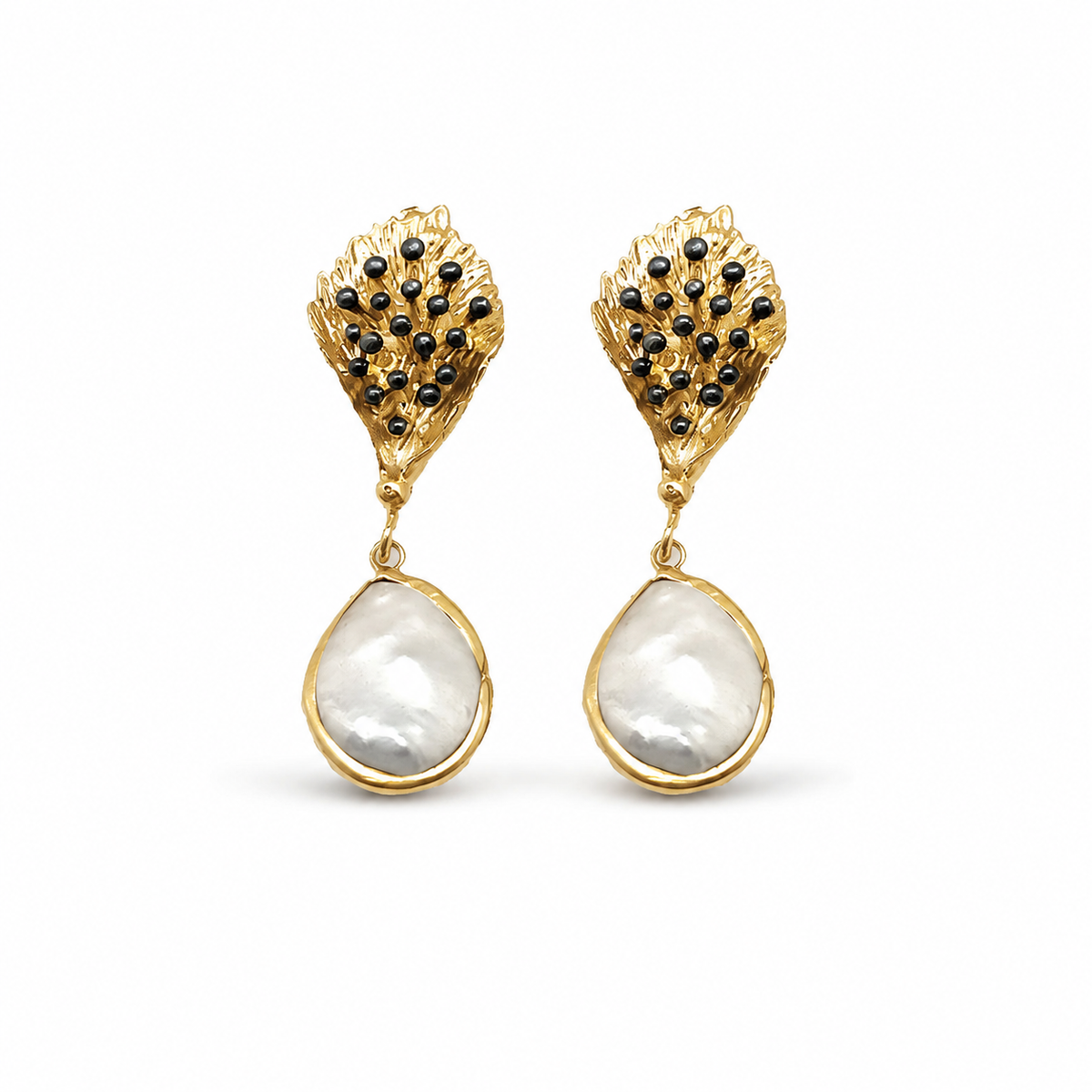 Pair of gold-tone drop earrings with textured leaf tops, black bead accents, and pearl-like drops.