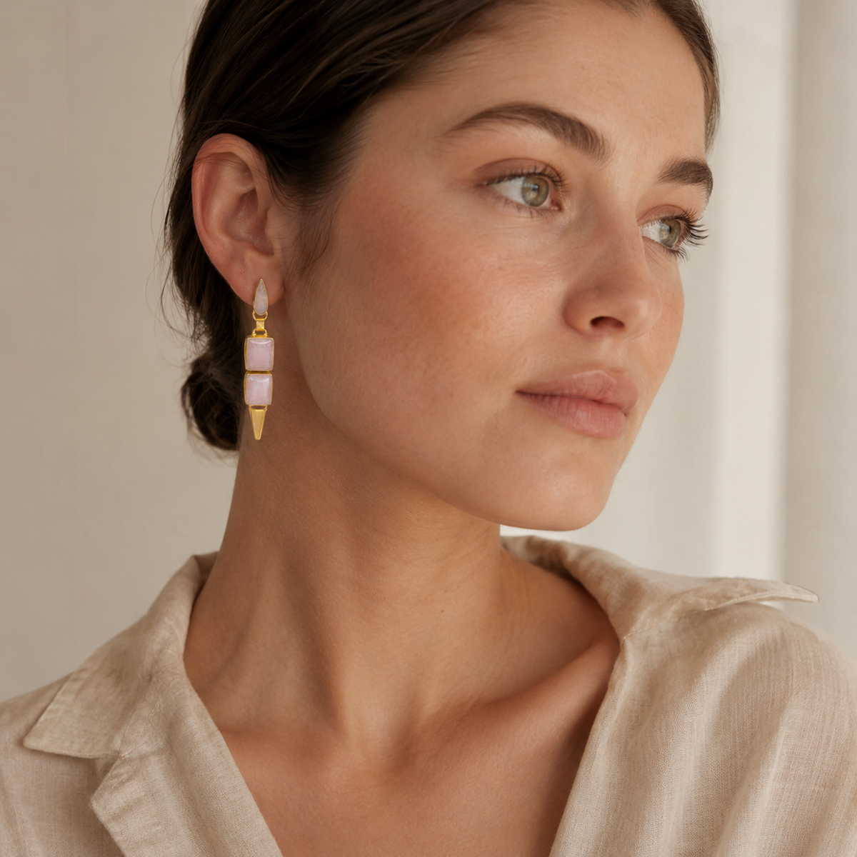 Pair of rose quartz-inspired drop earrings with a soft pink and gold look.