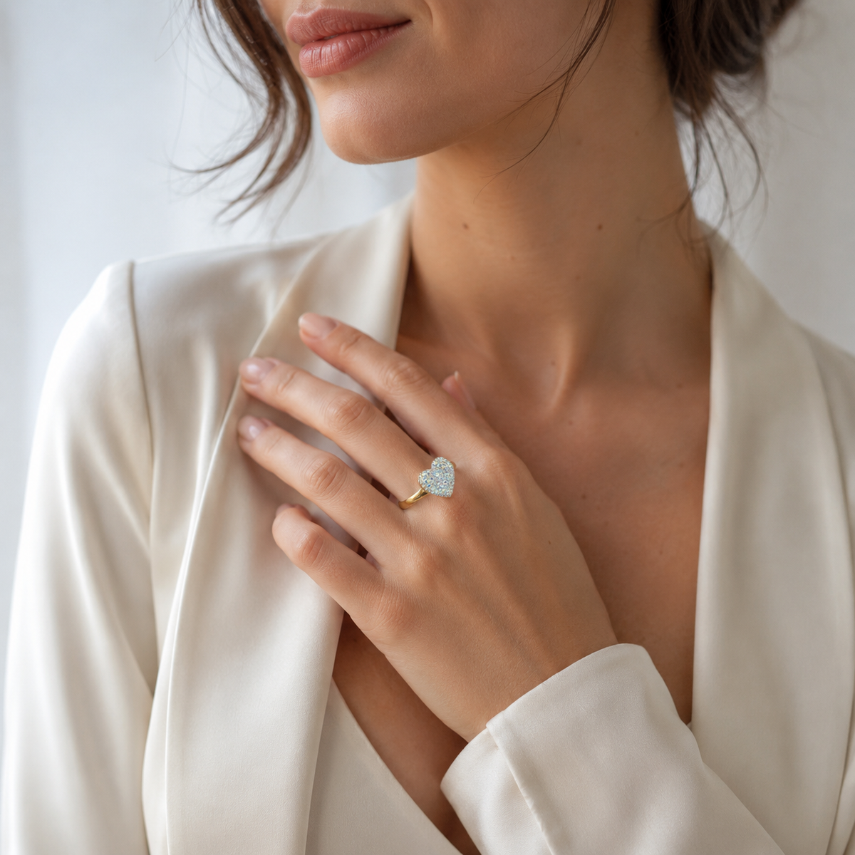 A gold-plated ring with a heart-shaped crystal design and luminous shine.