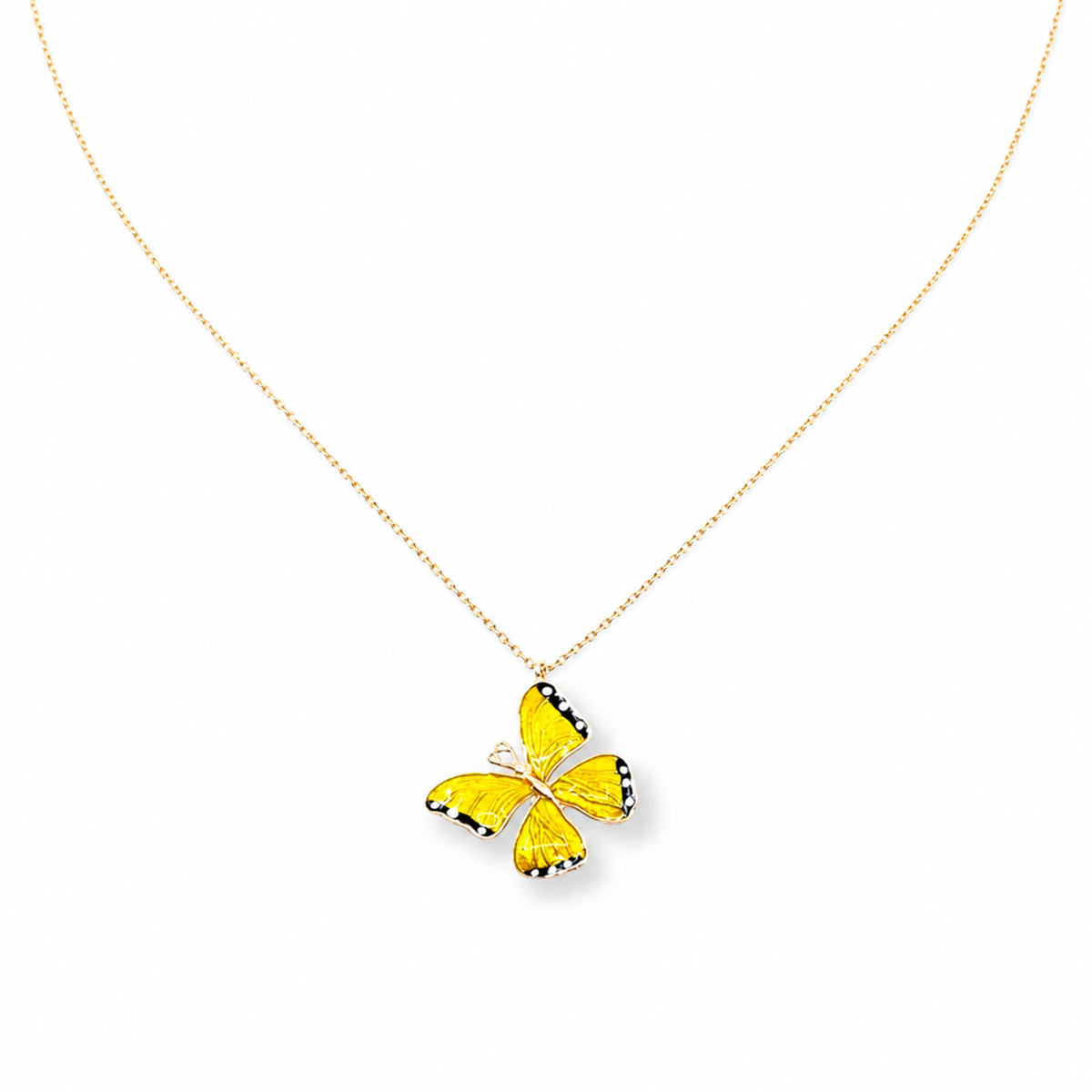 Yellow enamel butterfly pendant necklace on a fine gold-tone chain.