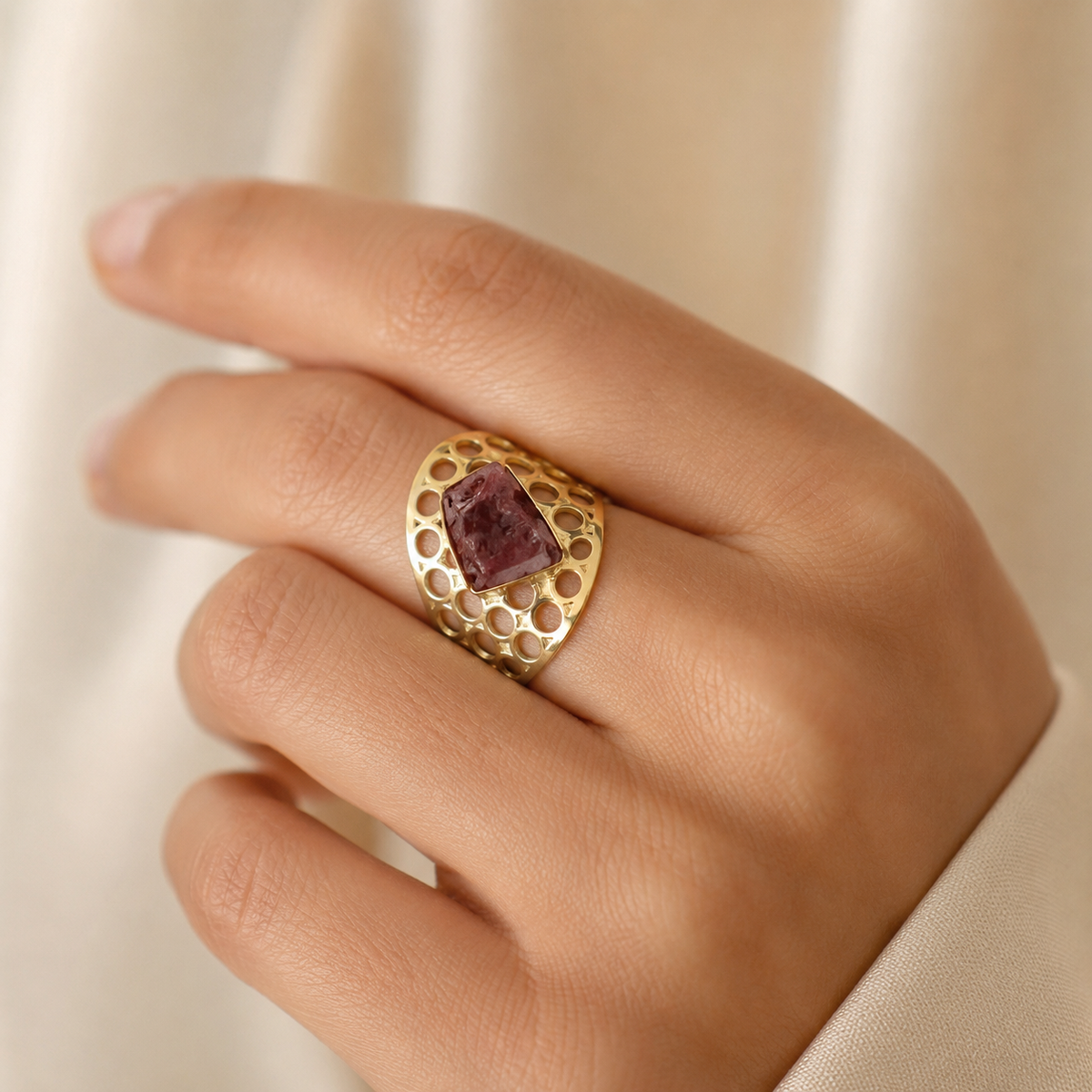 Raw garnet statement ring shown from a front angle on a white background.