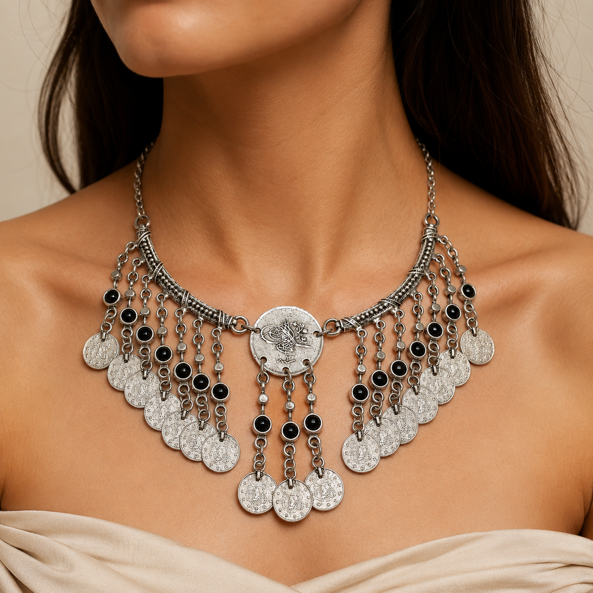 Antique silver necklace with black stone accents and layered coin fringe.