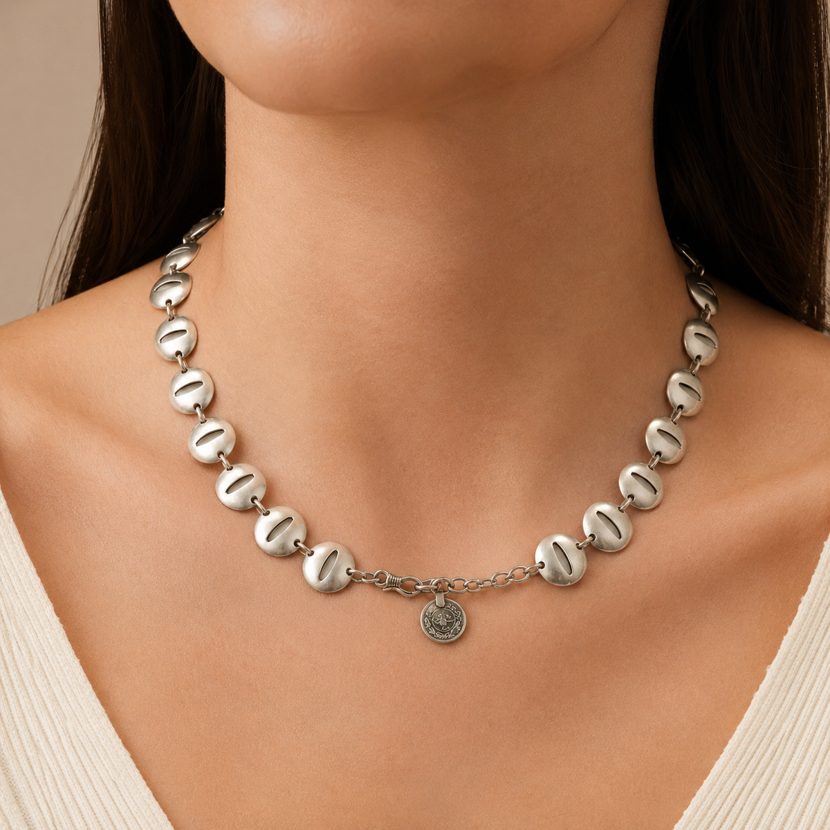 Silver-tone oval disc link necklace shown on a white background.