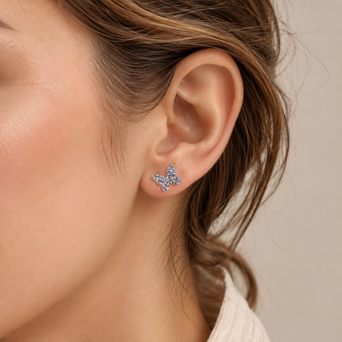 Butterfly stud earrings with bright multicolor CZ details on a white background.