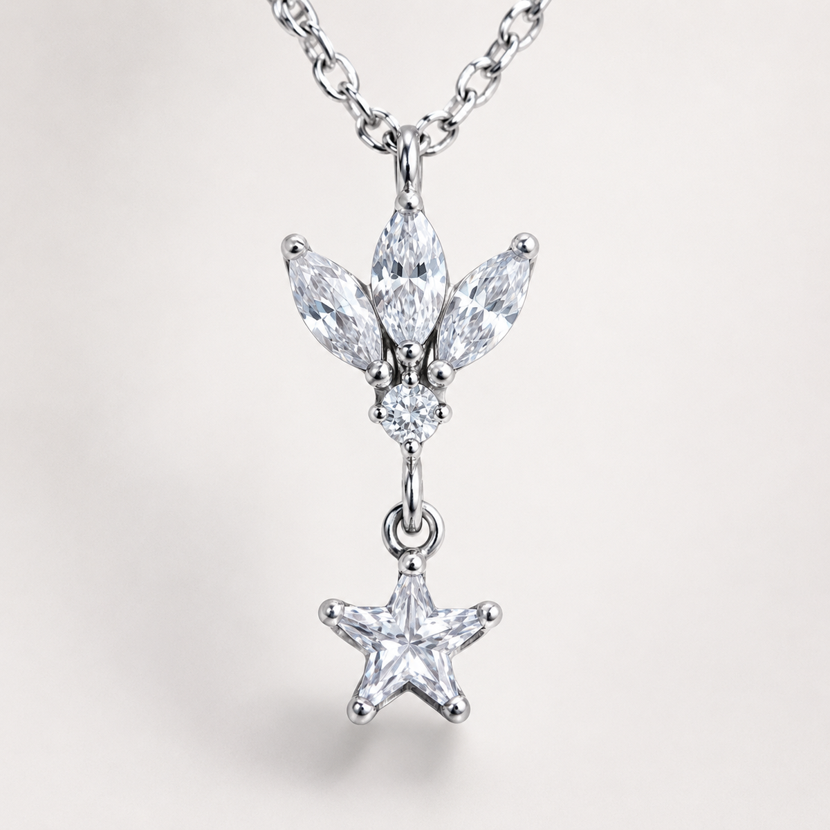 A close view of the lotus-inspired pendant and star drop detail.