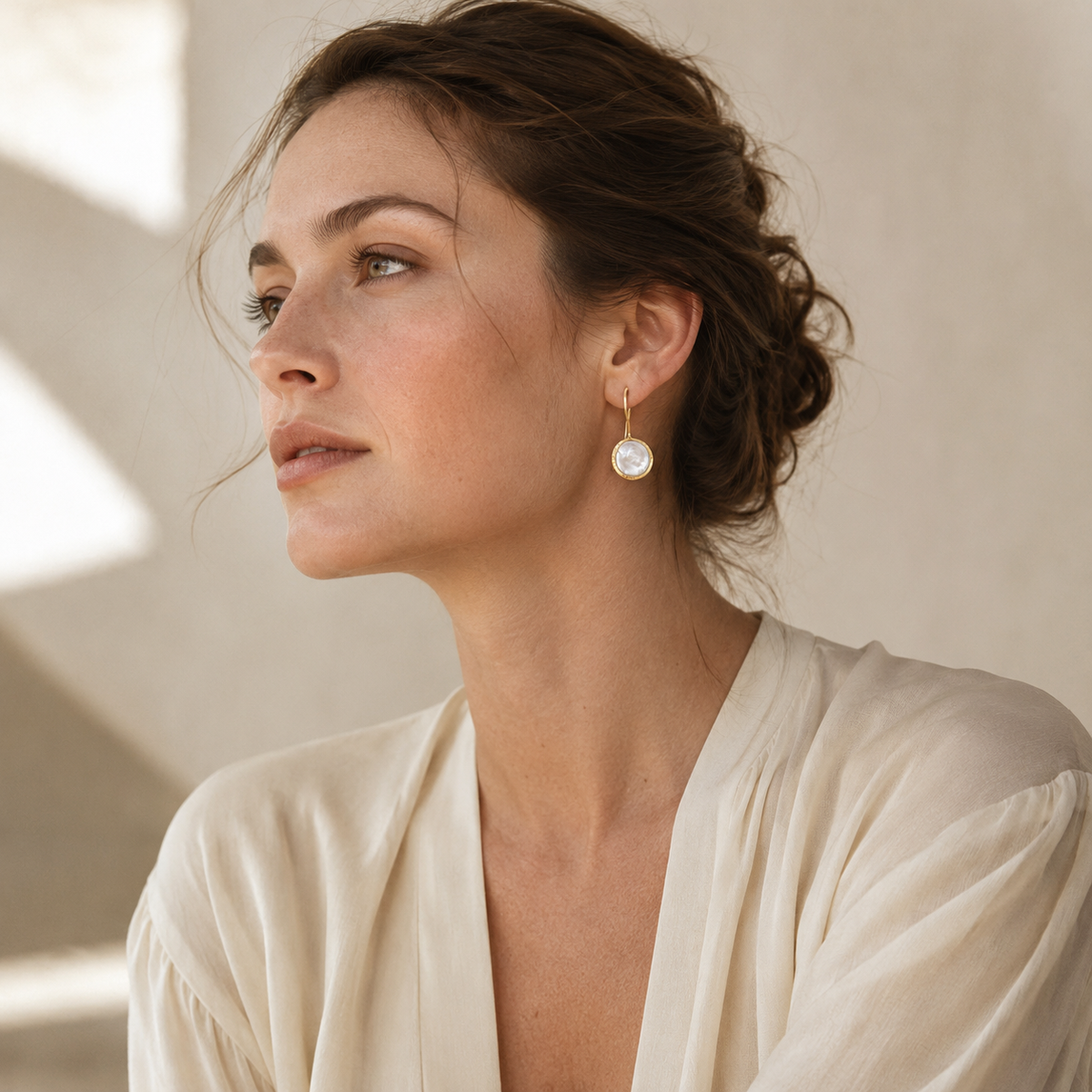 Gold-plated drop earrings with coin pearl centers shown as a pair.