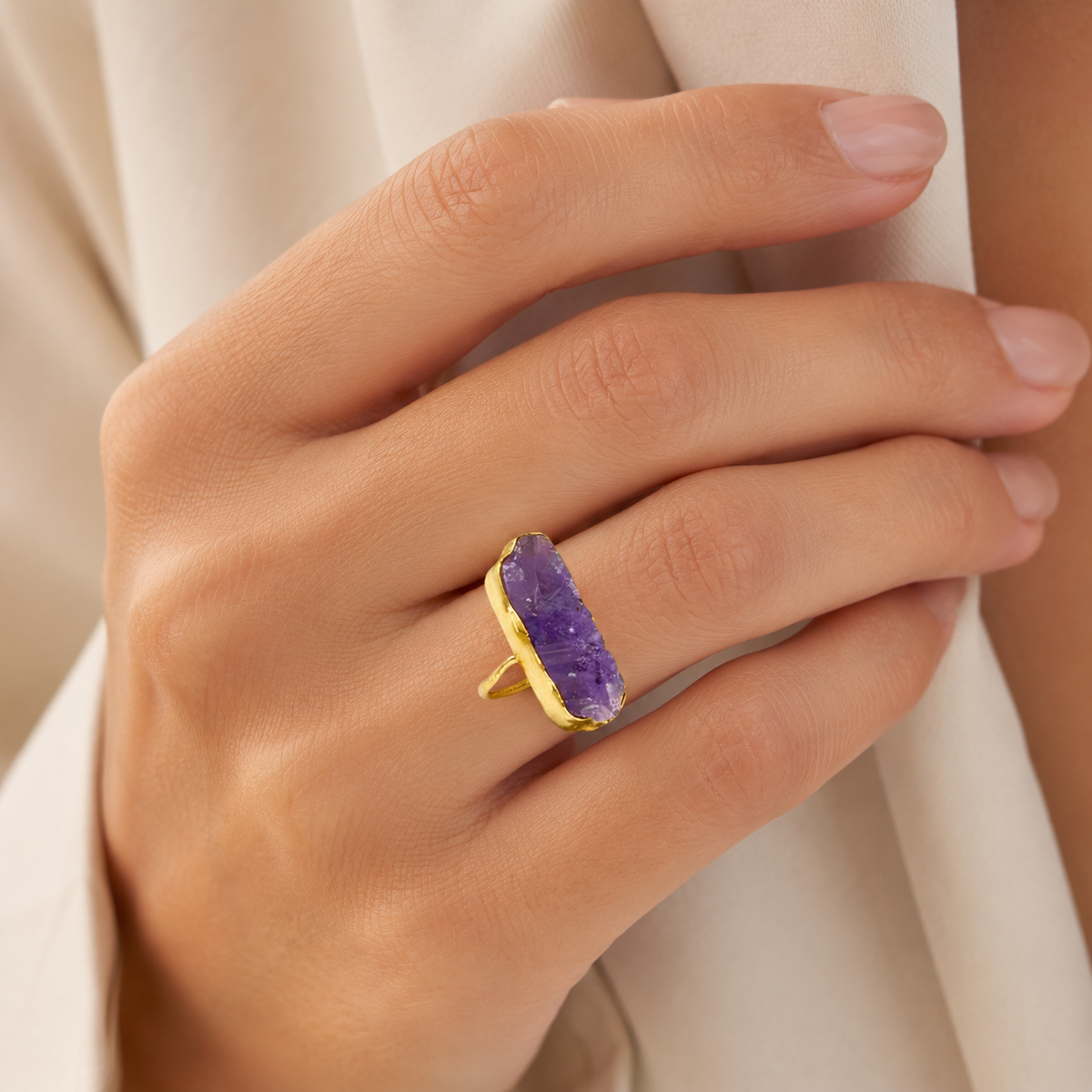 Raw amethyst bar ring shown at an angle with a gold-plated band.