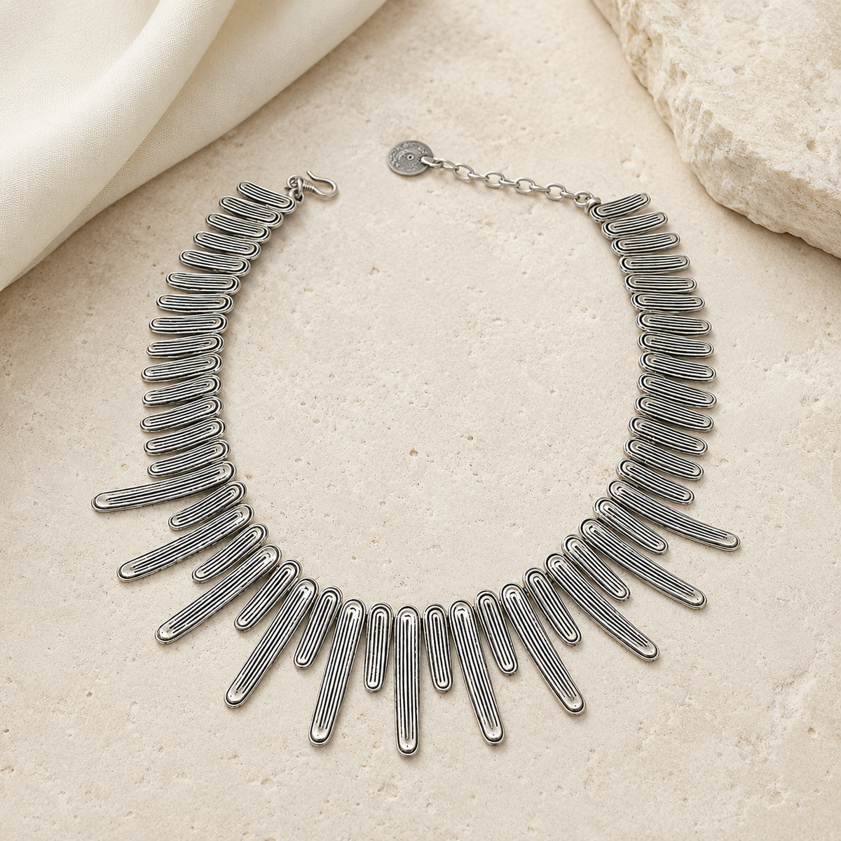 Silver-tone wave bar necklace styled as a collar piece.