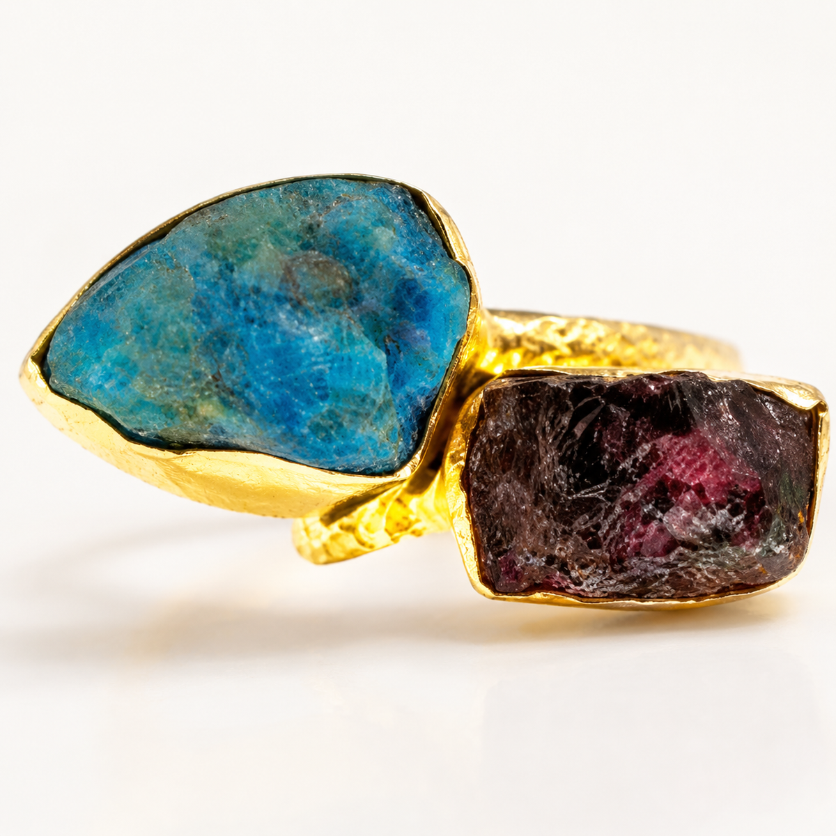 Close-up of the raw apatite and garnet stones in a gold-plated ring.