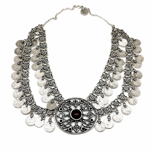 Silver-tone bib necklace with coin fringe and a red center stone.
