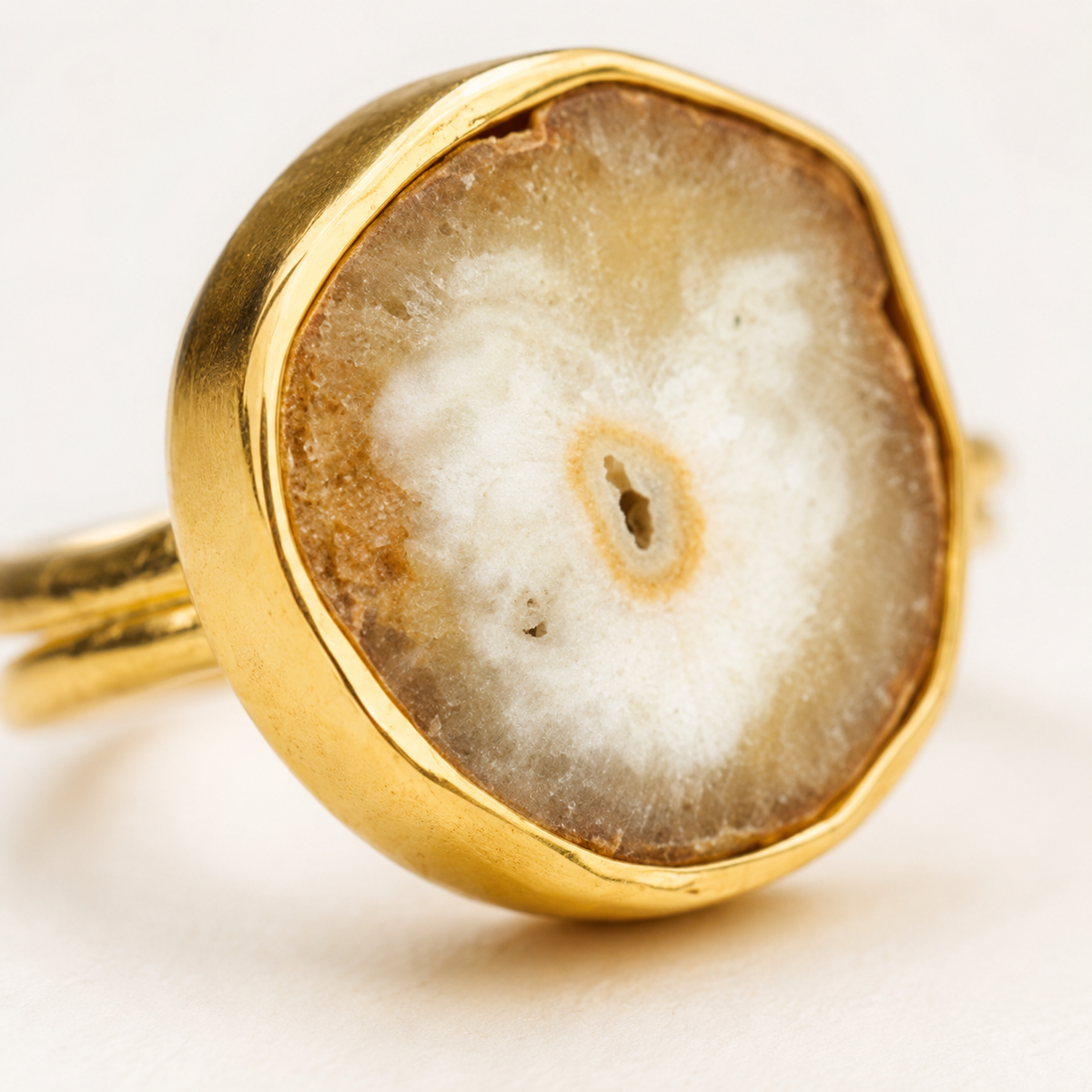 Close view of the solar quartz slice set in a gold-plated bezel.
