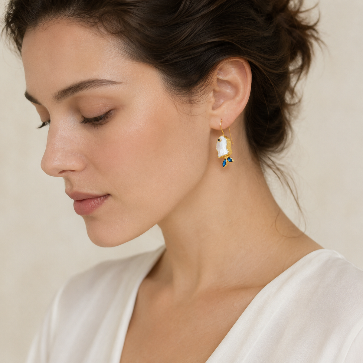 Gold-plated fish drop earrings shown from a clean product angle.