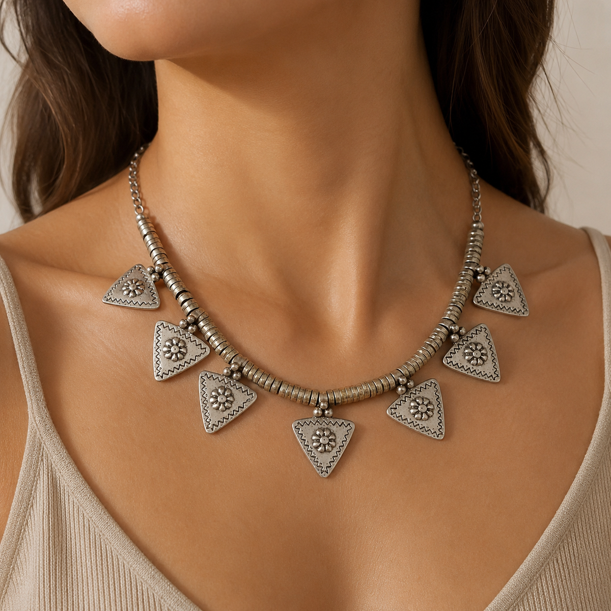 Silver-tone triangle flower charm necklace shown from the front on a white background.