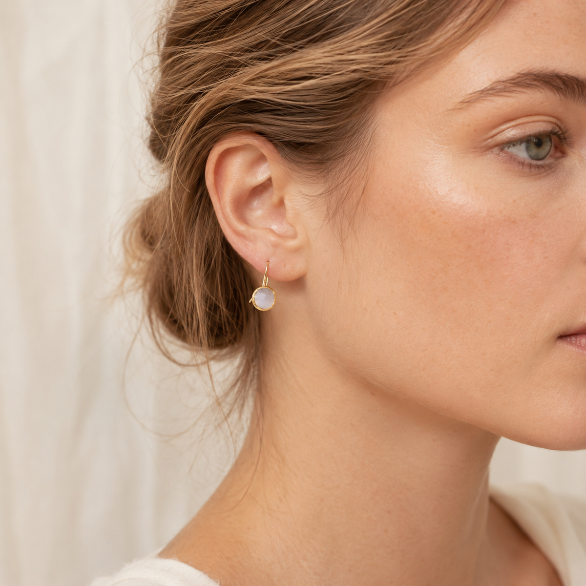 Moonstone drop earrings shown front view with gold-plated hooks.