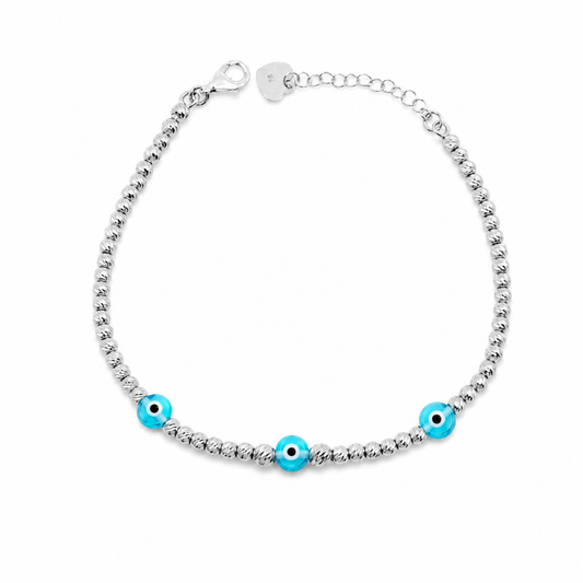 Silver bracelet with three blue evil eye accents and a beaded design.