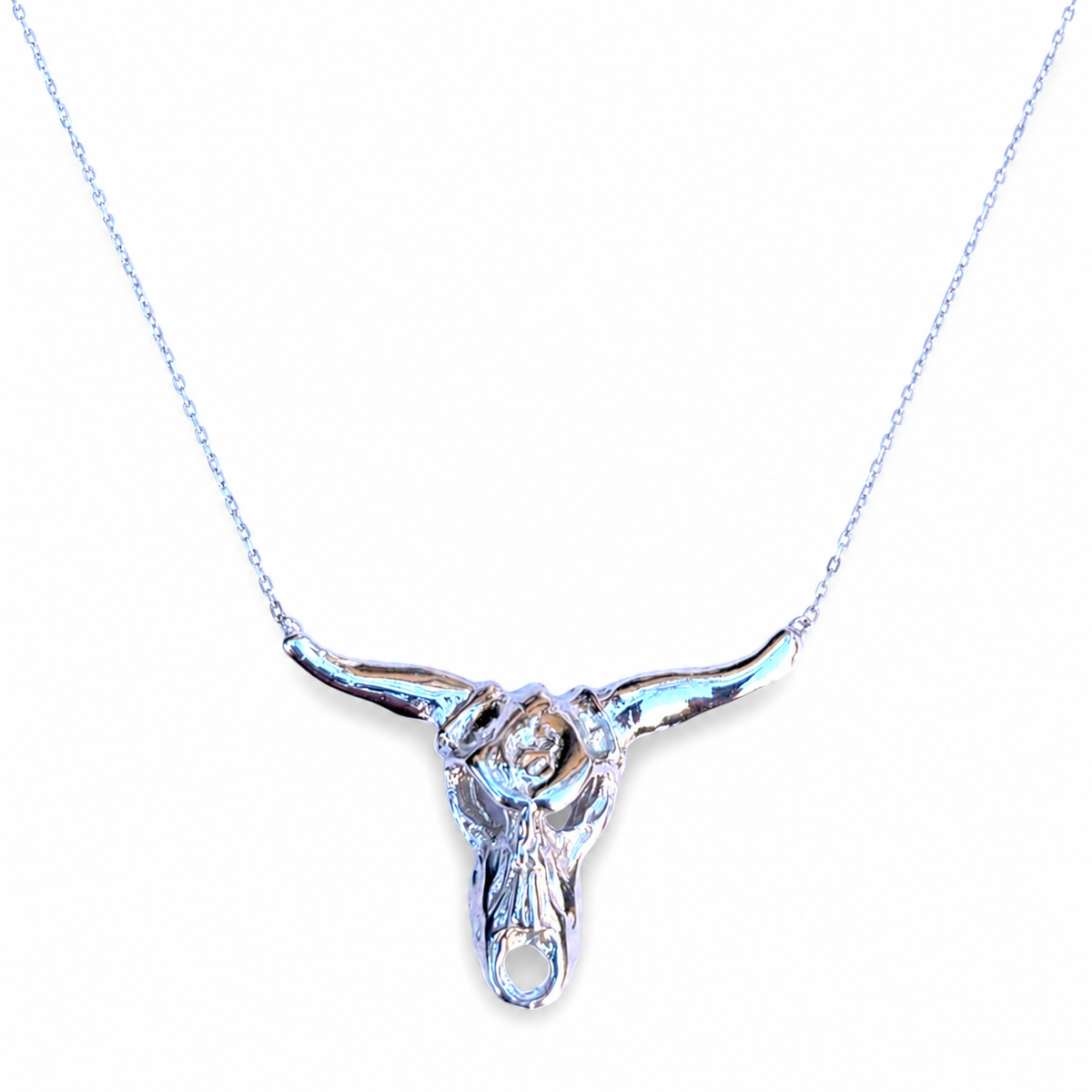 Silver-tone longhorn pendant necklace with a sculptural polished finish.