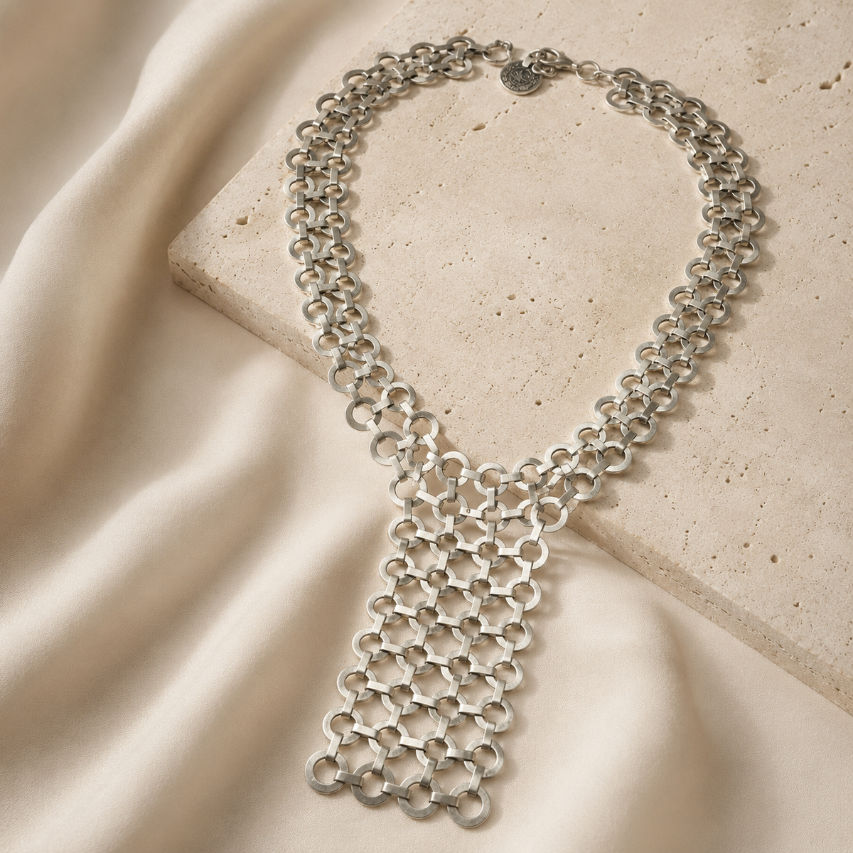Silver statement necklace with a bold layered link design.