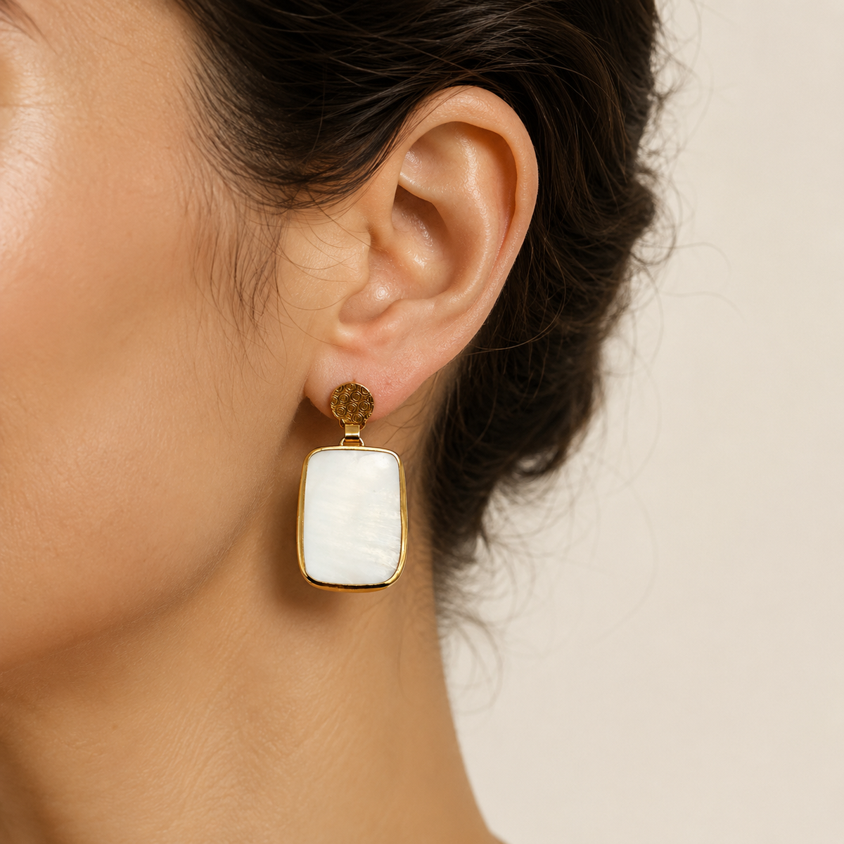 Pair of gold plated clear quartz drop earrings shown on a white background.