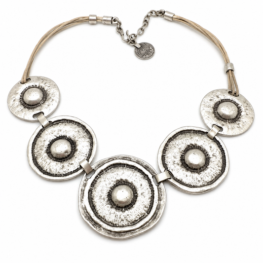 Hammered silver-tone circle statement necklace with textured round pendants.