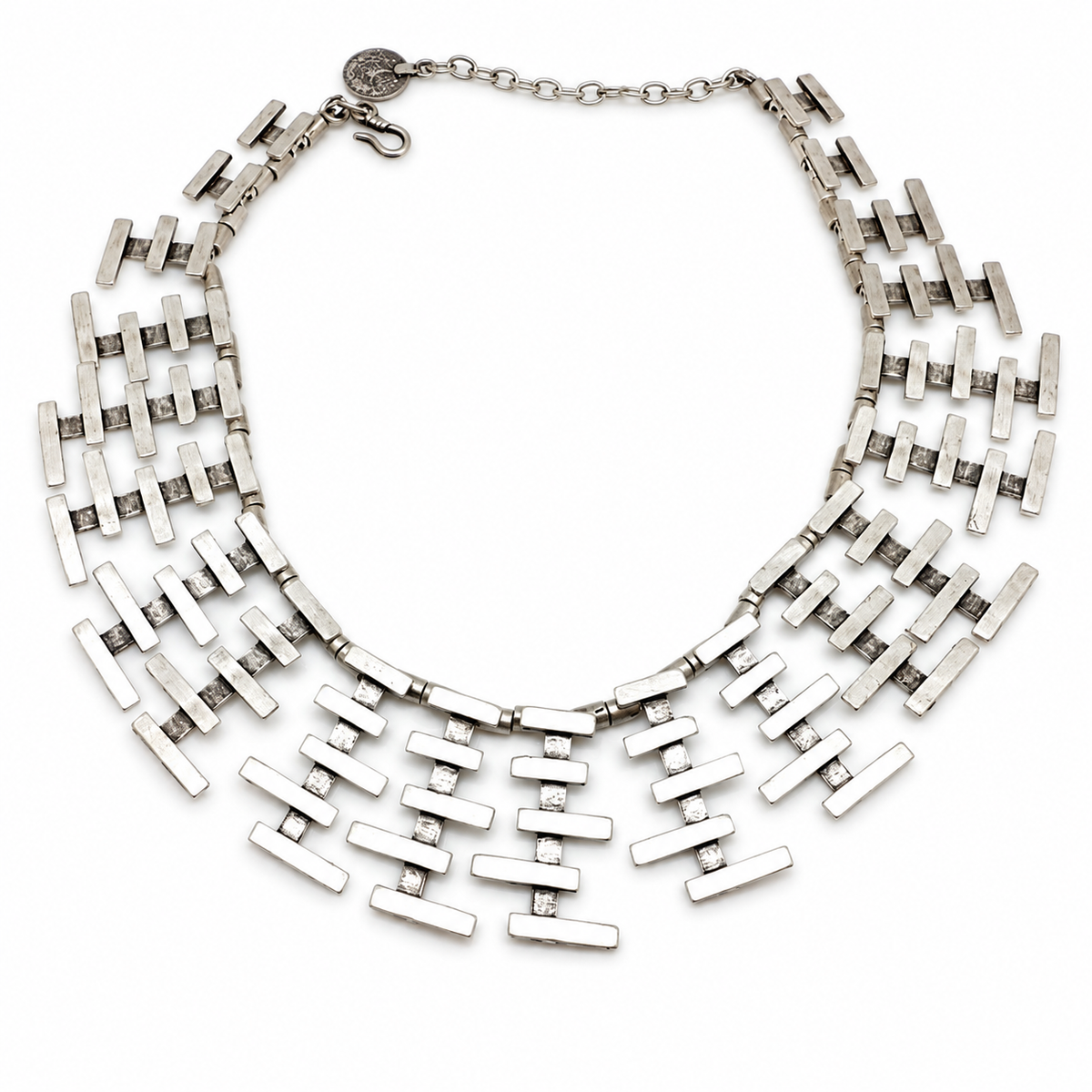 Silver-tone collar necklace with layered bar fringe and a sculptural shape.