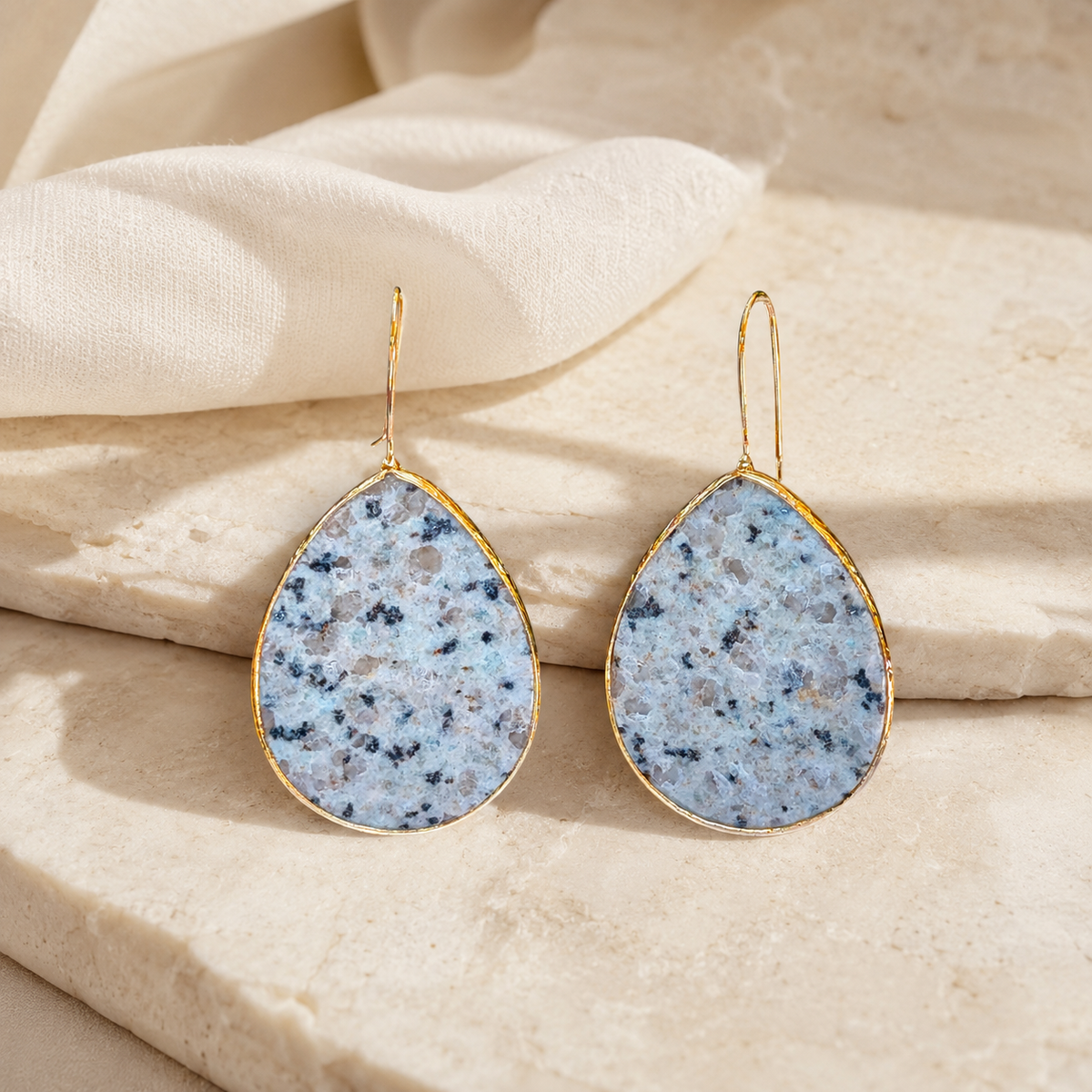Gold-plated teardrop earrings with soft blue-green amazonite stones.