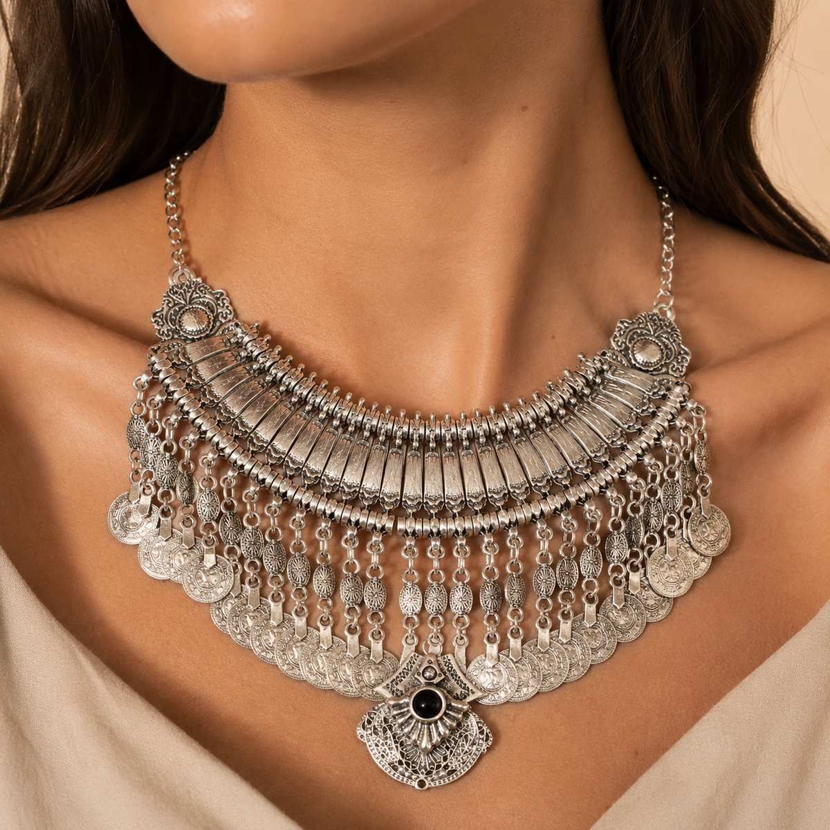 Silver-tone coin fringe necklace with a black stone pendant shown from the front.