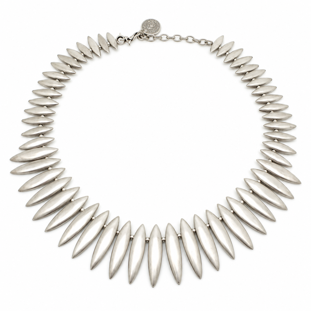Silver-tone collar necklace with leaf-shaped spike links arranged in a sculptural curve.