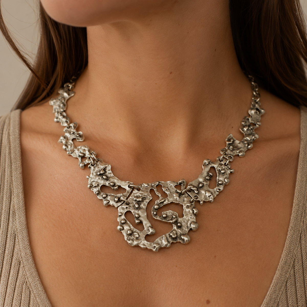 Organic silver-tone statement necklace shown from the front on a white background.