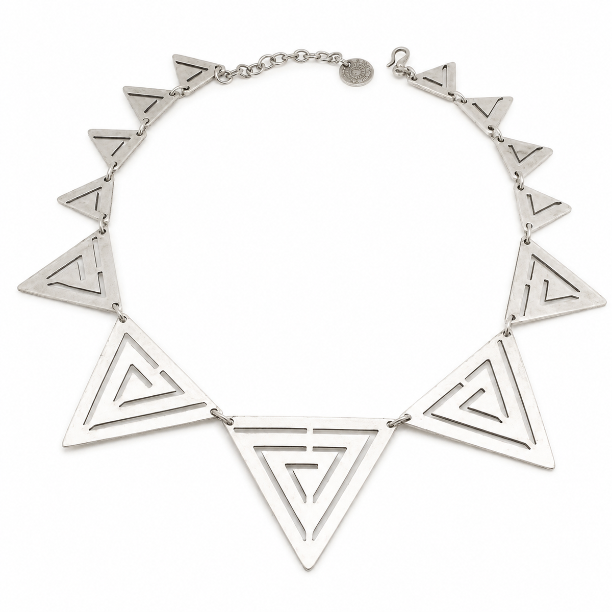 Silver-tone necklace with large triangle cutout pendants arranged in a geometric design.
