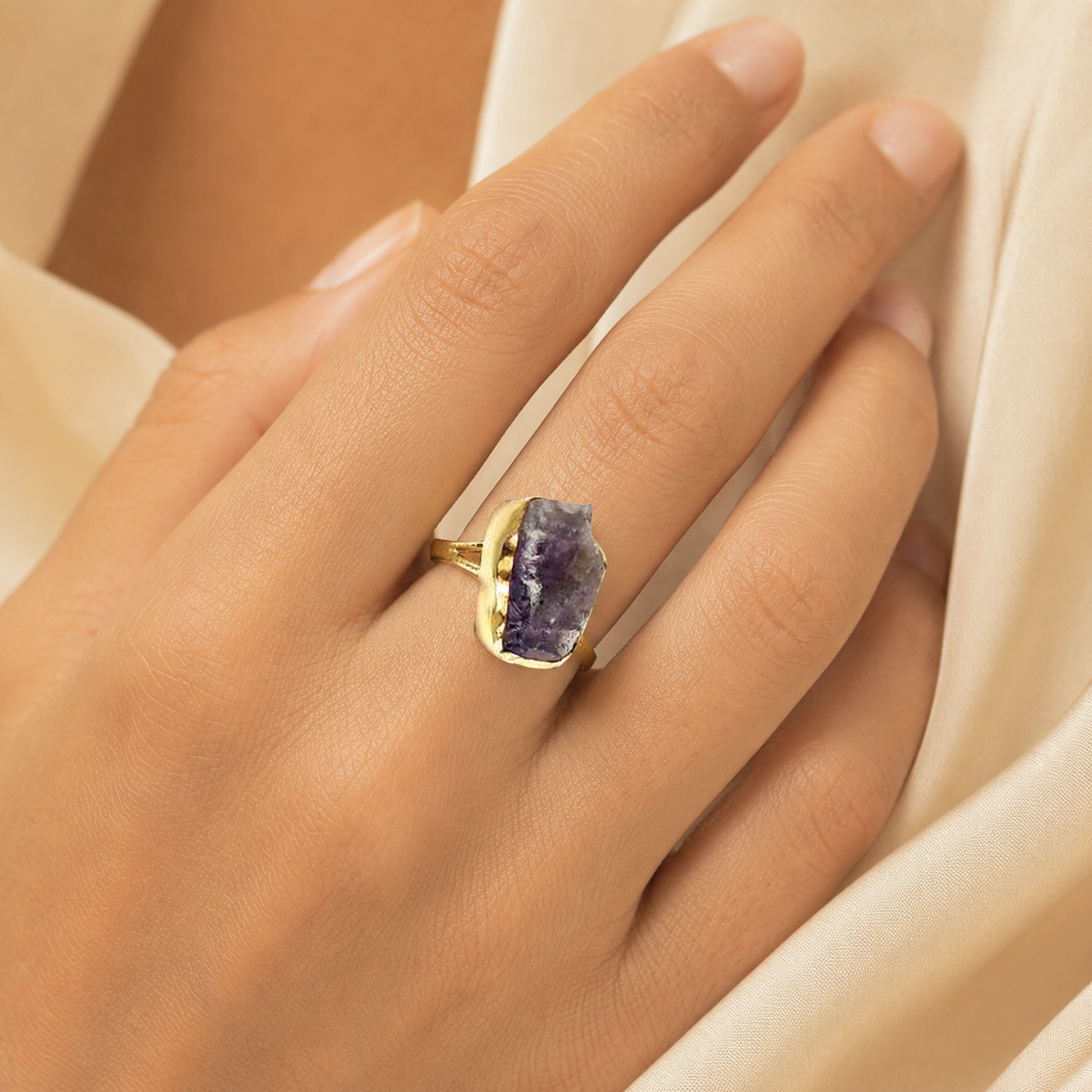 Raw amethyst statement ring with a gold-plated setting shown from the front.