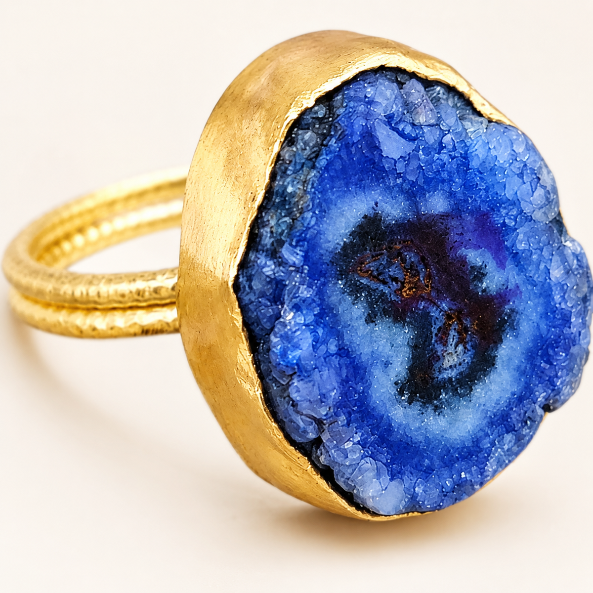 Close view of the blue druzy agate stone and gold-tone setting.