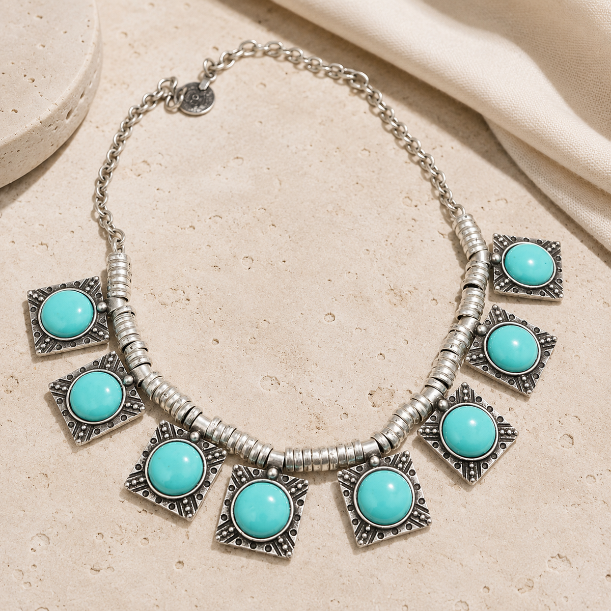 Turquoise star charm necklace with multiple pendant accents and a silver-tone chain.