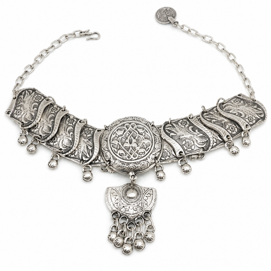 Silver-tone filigree choker necklace with an ornate medallion centerpiece and decorative drop accents.