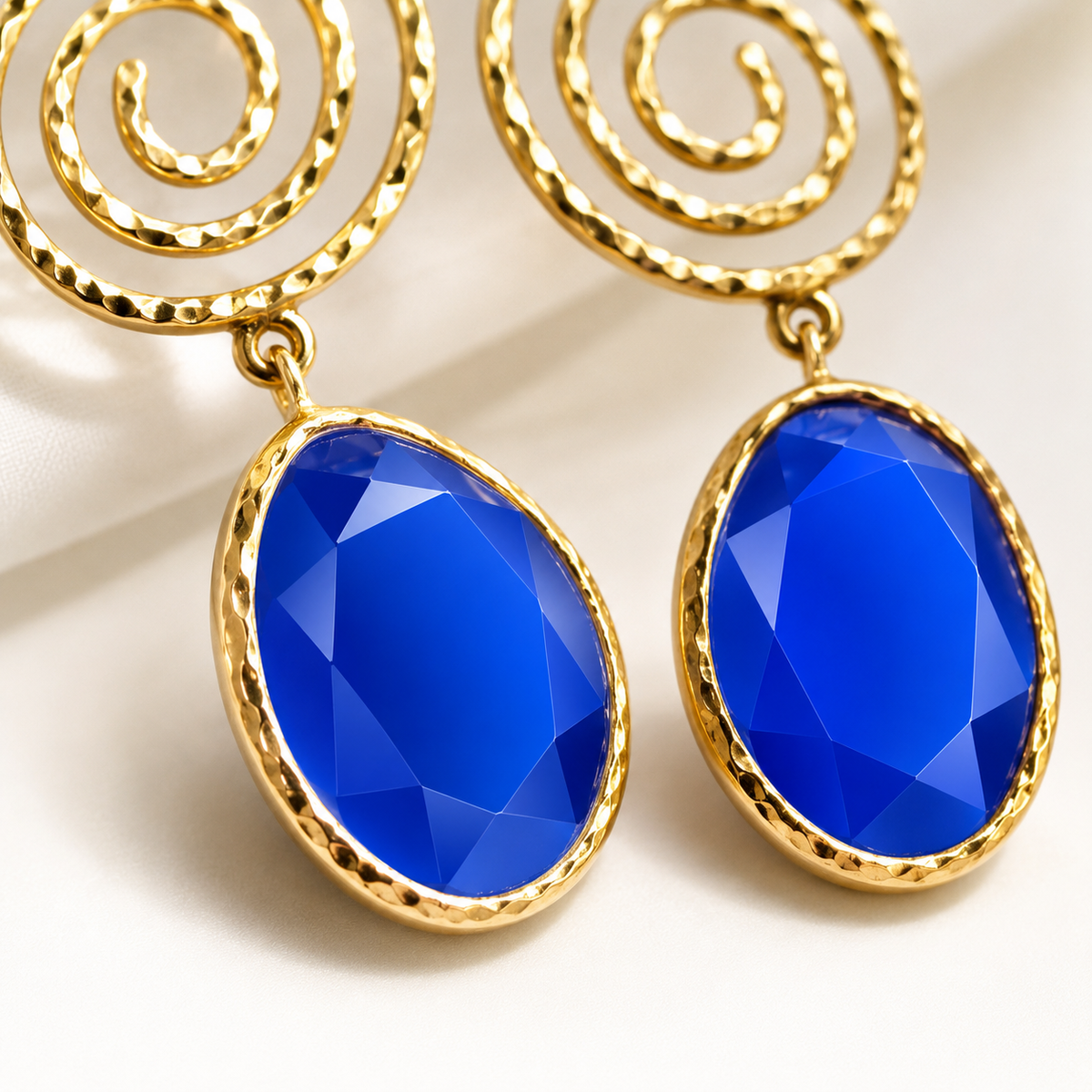 Close view of the spiral top and blue faceted drop detail.