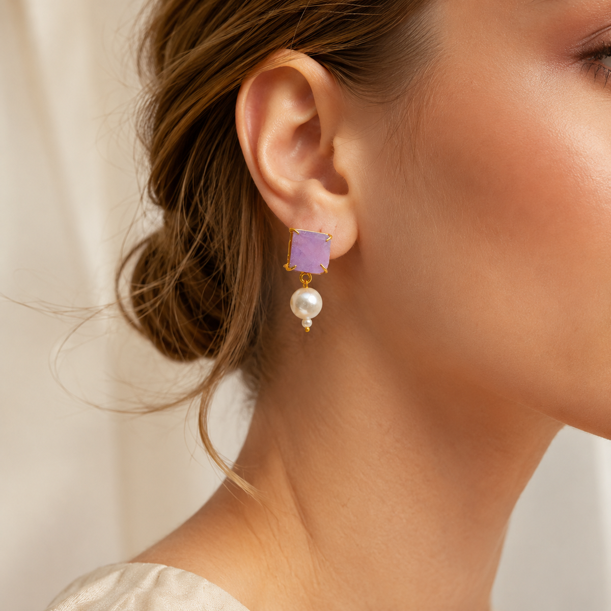 Front view of drop earrings with rough amethyst-style stones and pearl accents.