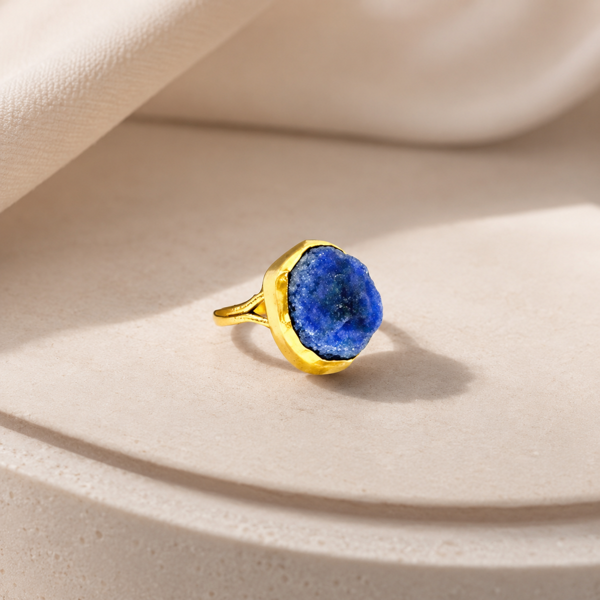 Gold-plated ring with a bold raw lapis lazuli center stone.
