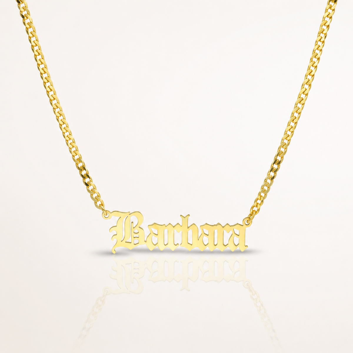 Gold-tone personalized name necklace with a polished chain and engraved name pendant.