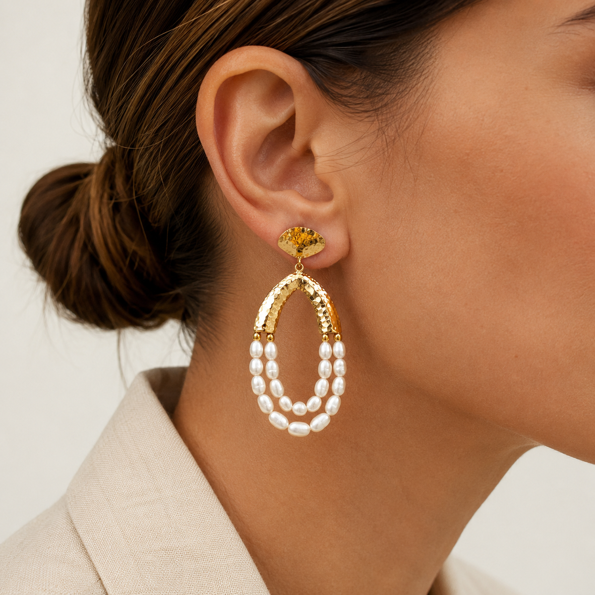 Pair of gold-tone chandelier earrings with hammered arches and layered pearl drops.