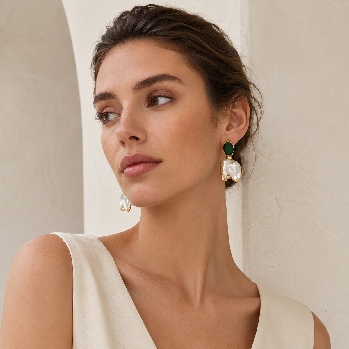 Statement drop earrings with green stones, baroque pearls, and gold-tone frames.