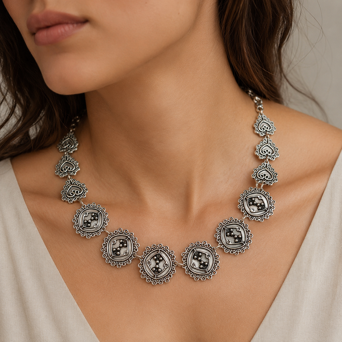 Silver-tone circle cluster link necklace shown on a white background.