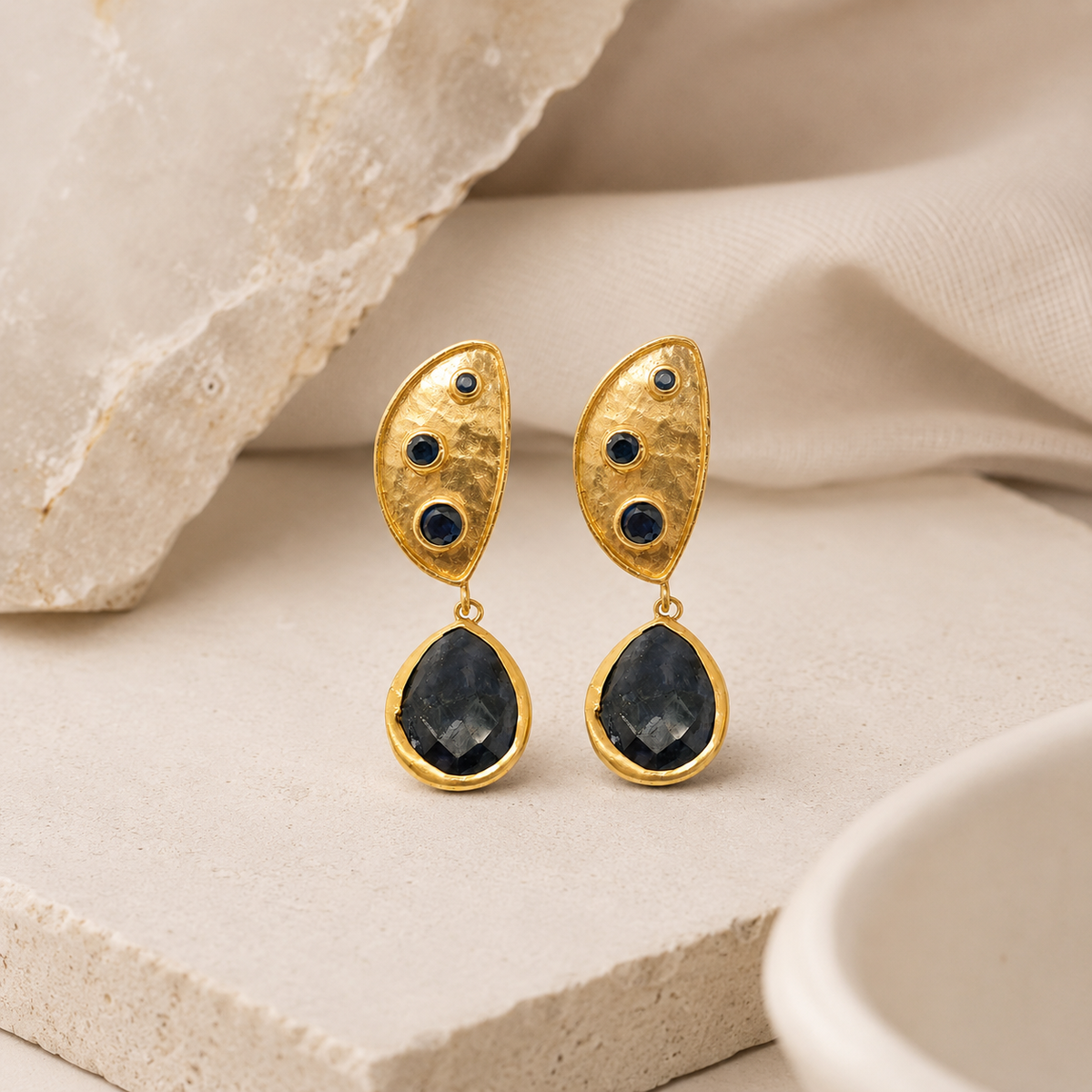 Pair of gold plated dangle earrings with a sculptural half moon shape.