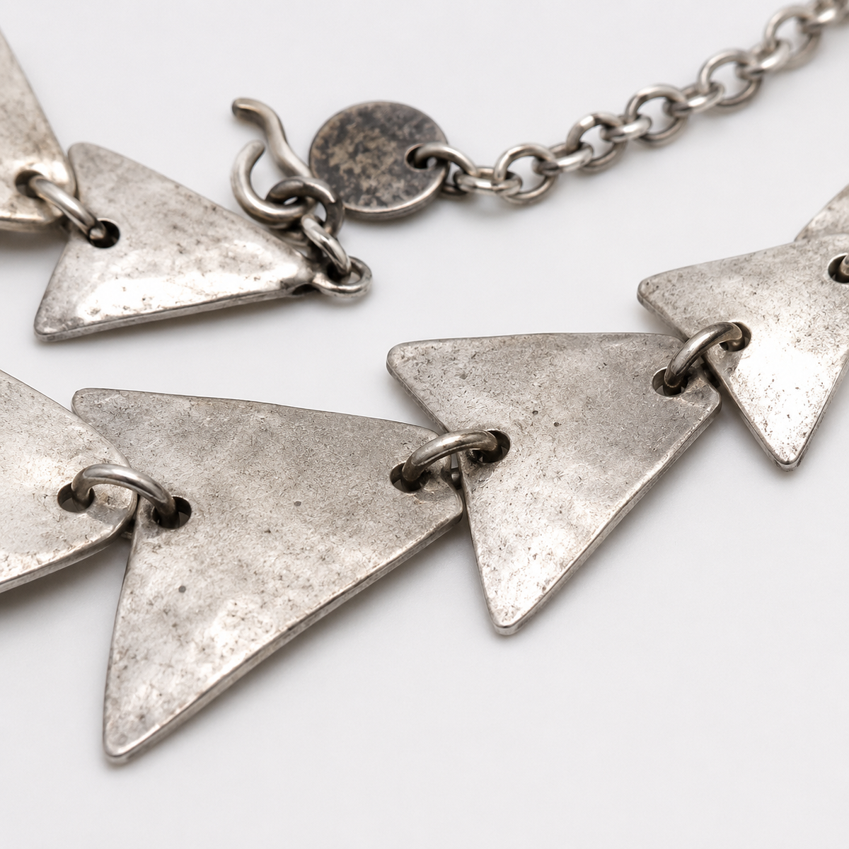 Close view of the textured triangle links and chain detail.