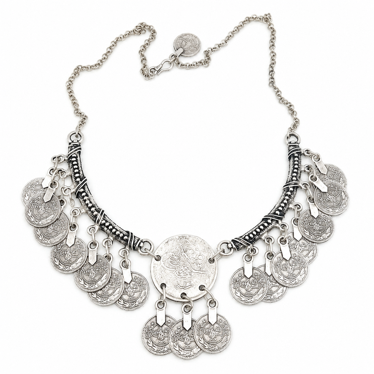 Silver-tone crescent pendant necklace with engraved coin fringe on a white background.